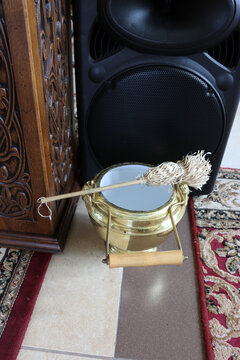 Church holy water bucket with aspergillum prepared for Orthodox worship and ceremonial blessing.