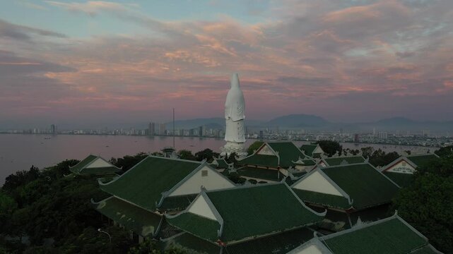 Aerial view of Linh Ung Pagoda and the iconic Lady Buddha statue on Son Tra Peninsula, Da Nang, Vietnam. Stunning Buddhist temple overlooking the sea with lush mountains and panoramic coastal scenery.