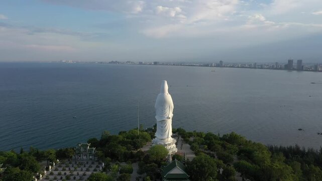 Aerial view of Linh Ung Pagoda and the iconic Lady Buddha statue on Son Tra Peninsula, Da Nang, Vietnam. Stunning Buddhist temple overlooking the sea with lush mountains and panoramic coastal scenery.