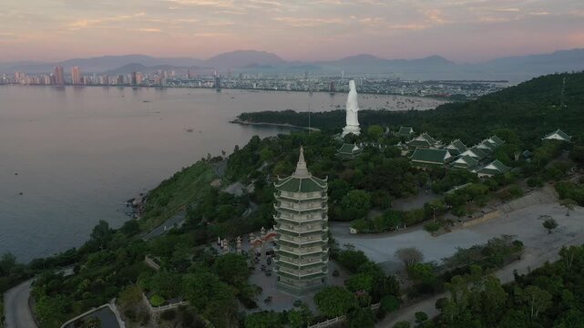 Aerial view of Linh Ung Pagoda and the iconic Lady Buddha statue on Son Tra Peninsula, Da Nang, Vietnam. Stunning Buddhist temple overlooking the sea with lush mountains and panoramic coastal scenery.