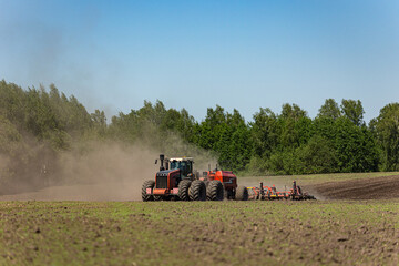 Obraz premium Modern tractor seeding farmland with precision agriculture equipment