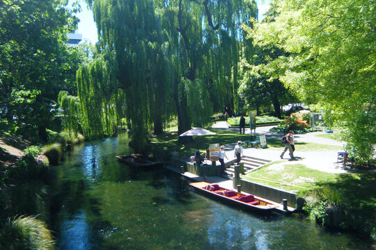 Punting on the Avon River with traditional punter and historic Gothic architecture in Christchurch, New Zealand before the 2011 earthquake