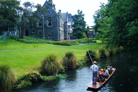 Punting on the Avon River with traditional punter and historic Gothic architecture in Christchurch, New Zealand before the 2011 earthquake
