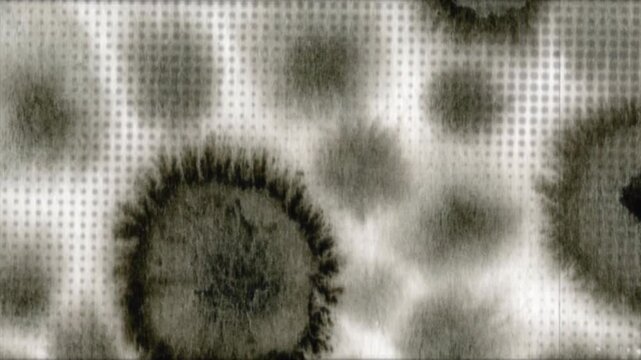 Vintage animated background featuring dark ink blots blooming across paper with halftone dot patterns, film grain texture, scratches, dust, and flickering light