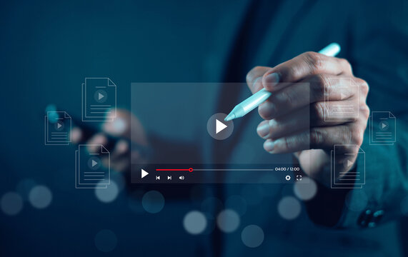 Businessman using a stylus pen interacting with a digital video player interface and media files. Concept of multimedia content creation, online education, video editing, and digital workflow.