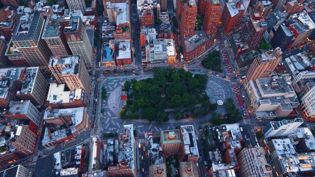 A spot of green nature in the lively vibrant cityscape of New York City, USA. Rising over the city at sunset.