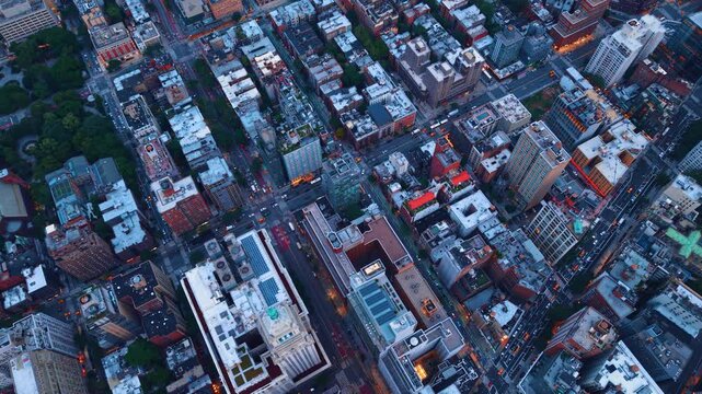 Footage over the blocks of modern New York City, USA. Lots of cars move by the streets of the metropolis at sunset.