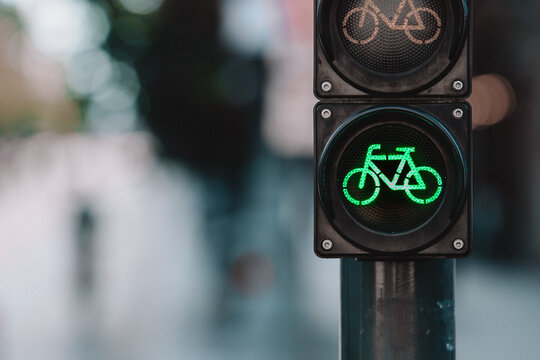 A bicycle traffic signal showing a green light in a bike-friendly zone, symbolizing sustainable urban transport and cycling infrastructure
