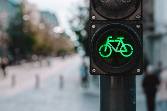 A bicycle traffic signal showing a green light in a bike-friendly zone, symbolizing sustainable urban transport and cycling infrastructure