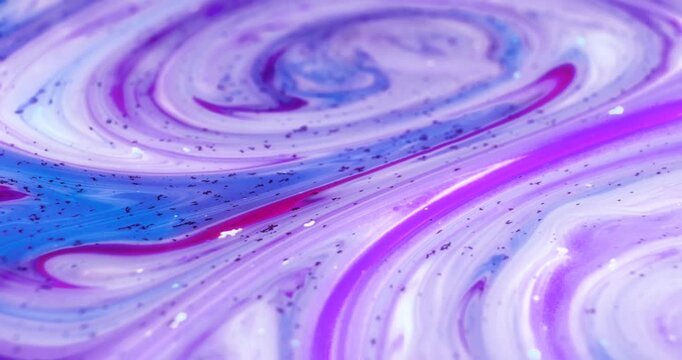Abstract fluid marble art featuring swirling purple, pink, and blue ink with shiny glitter. Elegant macro motion background for luxury branding, cosmetic visuals, artistic, and modern decorative conce