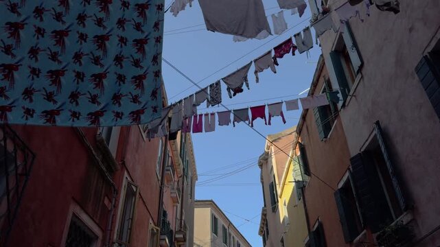 Sunny European alley with colorful laundry hanging above