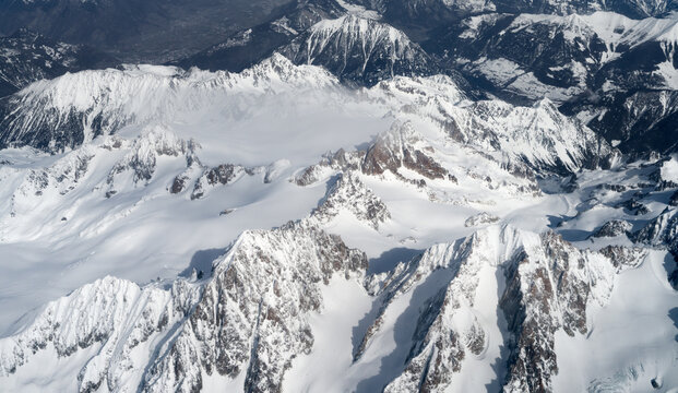 Alps aerial view, snow-capped mountains background