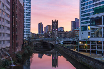Fototapeta premium View along the River Irwell at sunrise towards Manchester Cathedral, England, Uk