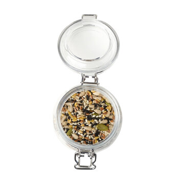 Glass jar filled with mixed seeds and grains on a white background