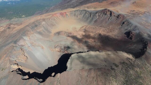 An aerial pull back and boom up drone shot revealing the magnificent Pico Viejo volcano crater on Tenerife, Canary Islands. Capturing the rugged, otherworldly volcanic landscape.
