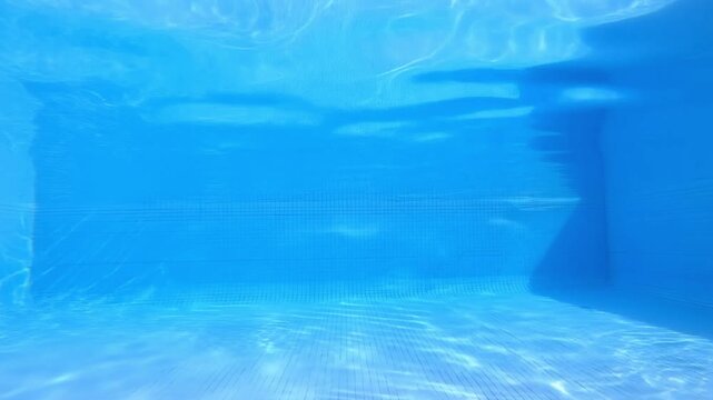 clear blue swimming pool underwater background with water caustics ripple
