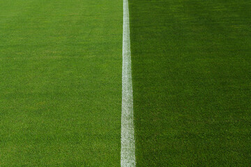 Obraz premium textured soccer game field with free copy space background - line in stadium midfield