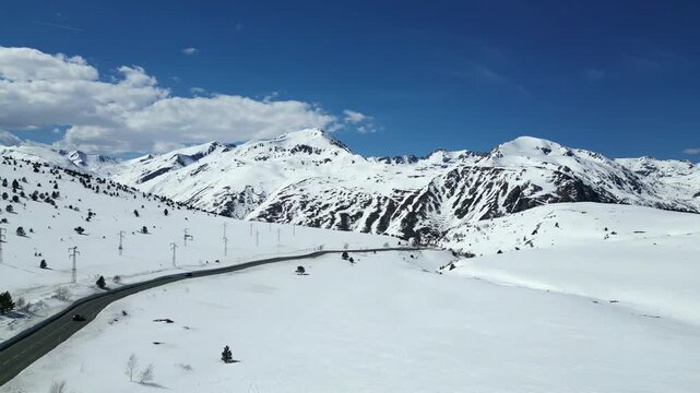 Aerial View of Mountain Pass Road Below Snowy Pyrenean Peak, Andorra 4k drone