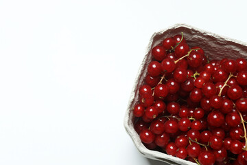 Redcurrant berries with green leaves on a white background. © Pixora ST 