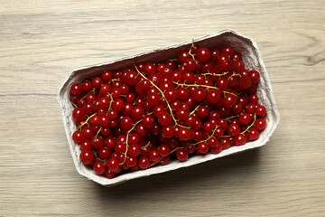 Redcurrant berries with green leaves on a white background. © Pixora ST 