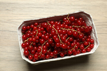Redcurrant berries with green leaves on a white background. © Pixora ST 