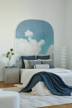 Inviting bedroom with cloud mural, a blend of blues and whites, creating a serene and dreamy retreat space