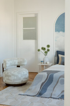 Minimalist Bedroom Interior with Stylish Accent Chair and Abstract Blanket