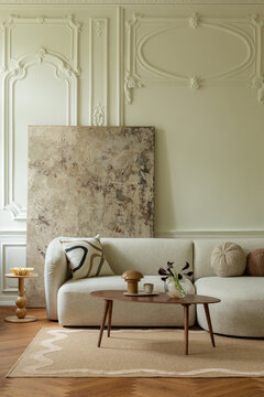 Elegant Living Room Interior with Neutral Sofa and Artistic Wall Decor in a Classic Setting, Cozy and Modern
