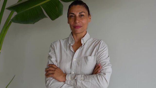 Latin american business woman looking on camera inside corporate office - Entrepreneur, elderly person and empolyee  concept