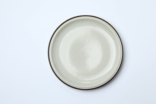 Top view of empty round plate on colorful background,Empty dish on napkin with space for your design.
