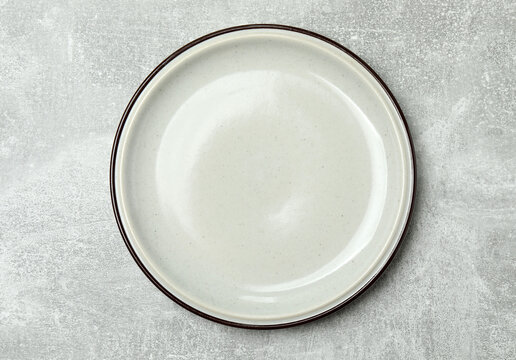 Top view of empty round plate on colorful background,Empty dish on napkin with space for your design.
