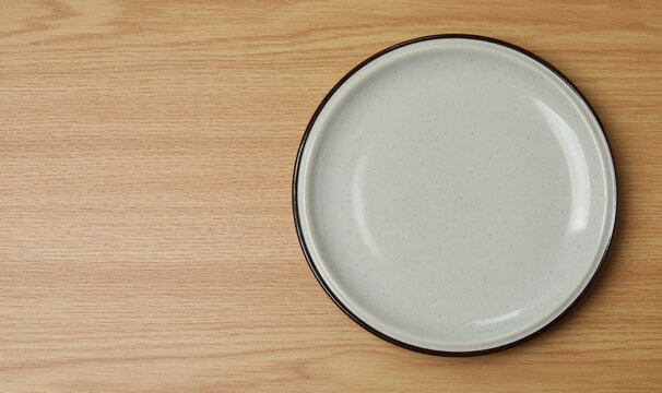 Top view of empty round plate on colorful background,Empty dish on napkin with space for your design.
