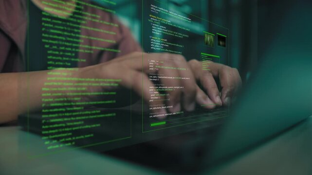 Programmer hands typing on laptop computer keyboard with green computer code digital visual overlay. Concept of cyber security, software development, data encryption and system hacking.