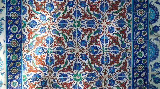 Close up shot of intricate patterned ceramic tiles with blues reds and greens