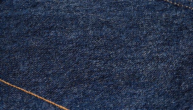 Macro view of indigo blue denim fabric texture with visible stitching line material clothing stitching background tailoring abstract fashionable industrial bluejean textured wearable