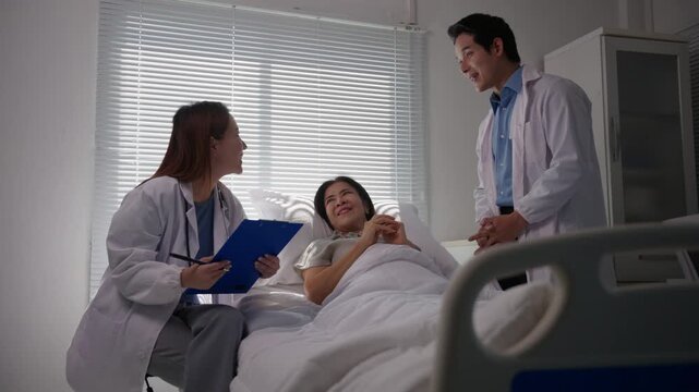 Two friendly doctors visiting a female patient in a hospital room, reassuring her about her health condition and discussing the positive results of her treatment plan