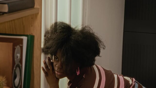 African American young woman and Caucasian young men looking through glass door, screaming in terror at scary hand silhouette. Perfect for Halloween marketing or security ads