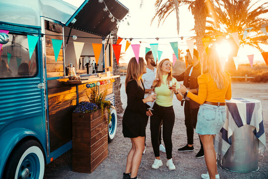 Content millennials hanging out near truck bar
