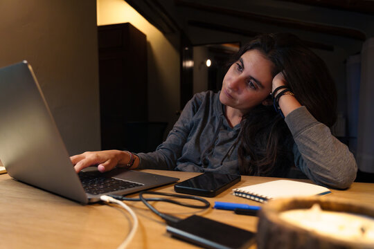 Tired Woman Working Late on Laptop at Night at Home