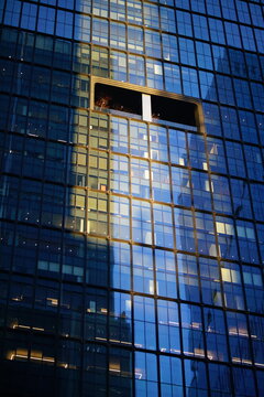 Modern glass skyscraper on sunset 
