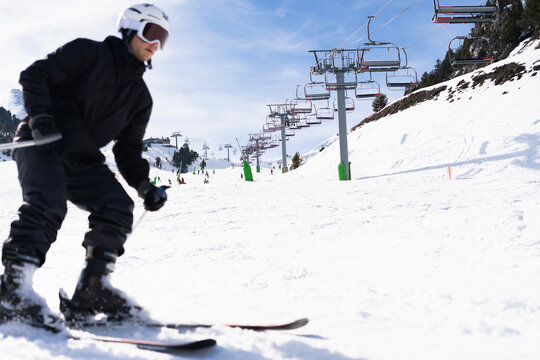 A skier descending a snowy slope. Copy space