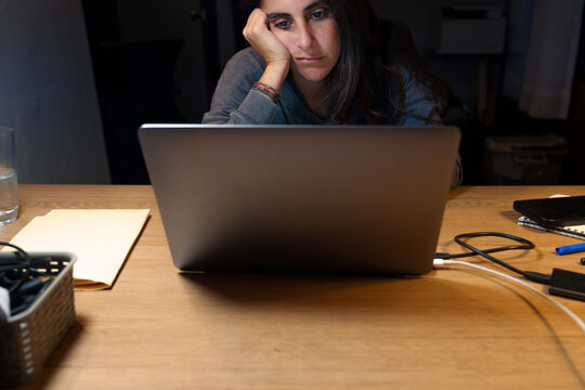 Tired Woman Working Late on Laptop at Night at Home