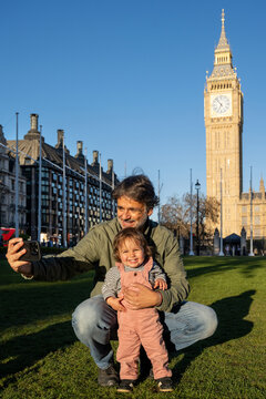 Parent Taking Selfie With Smiling Toddler In Front Of Big Ben