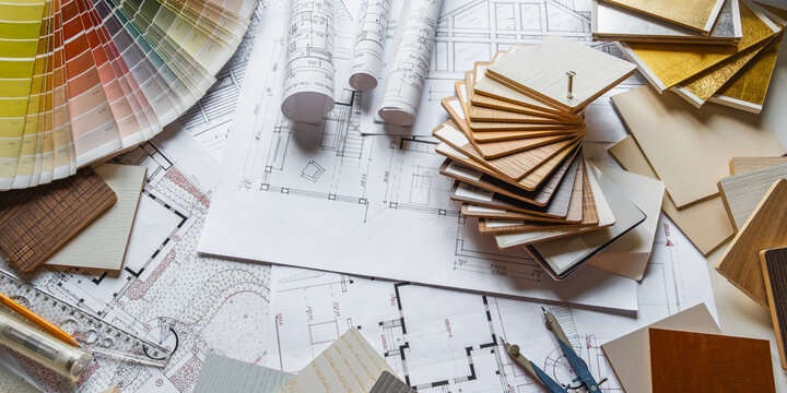 Interior design, architectural blueprints, wood veneer and finish samples, color palette, material selection, renovation planning, architect workspace flat lay.