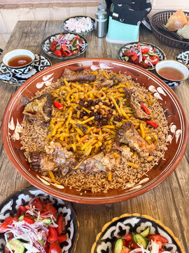 Samarkand Style Pilaf, Salad And Black Tea at a Dining Table