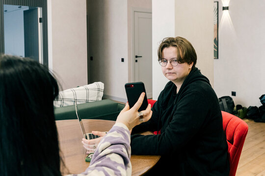 Friends share information over the phone.