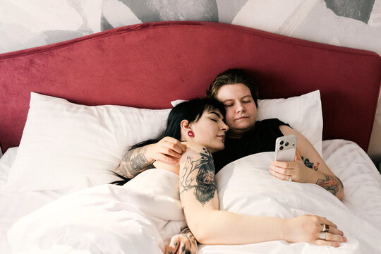 Friends like to spend time together in bed.