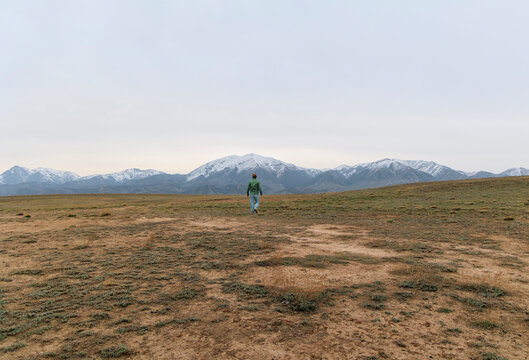 Lone Hiker Back View on Remote Wilderness.