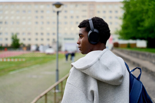 Young Person Walking With Headphones in an Urban Setting