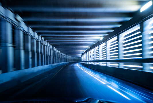 Driving Through a Blue Lit Tunnel in an Urban Setting